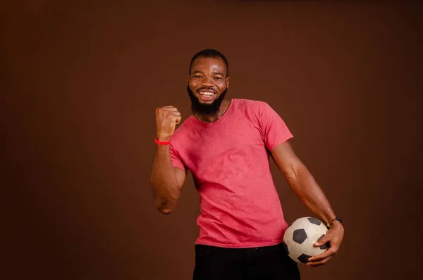 Attractive Happy African Man Holding Soccer Ball Isolated Brown Background — Stock Photo, Image
