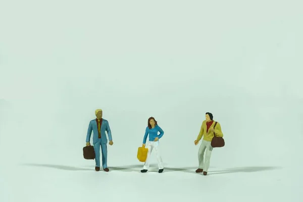 Traveling people with luggage, white background, miniature figures scene