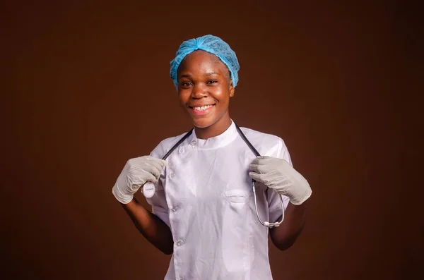 Счастливая Молодая Черная Медсестра Смотрит Камеру Изолированную Коричневом Фоне — стоковое фото