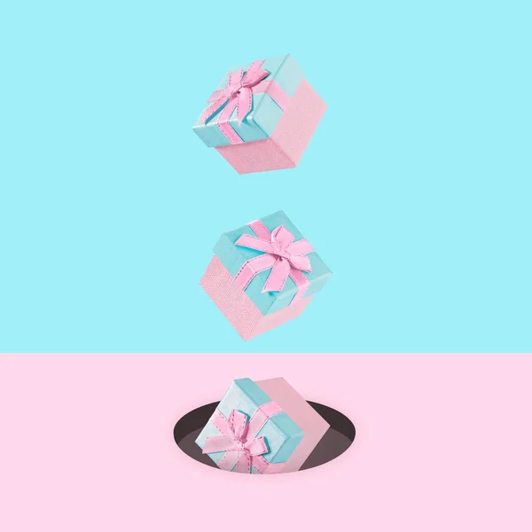 stock image Pastel pink Christmas gift boxes on blue and pink backdrop falling down-New Year present concept