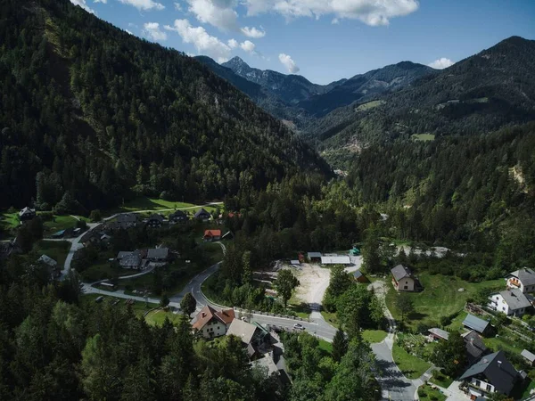 stock image A beautiful view from a drone of a village with curly road surrounded by mountains in Slovenia