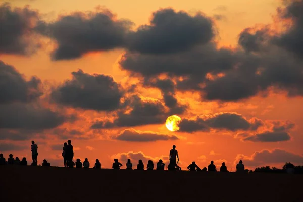 stock image A group of people enjoying the sunset