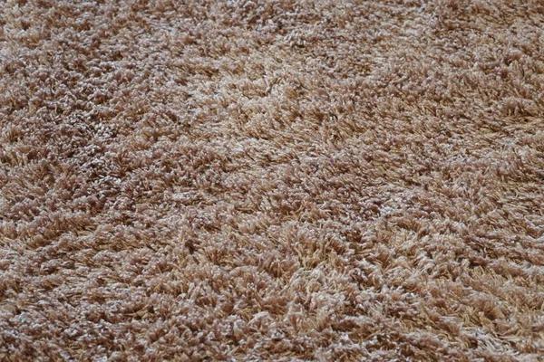 ぼんやりとした茶色の敷物の上の詳細のクローズアップショット — ストック写真