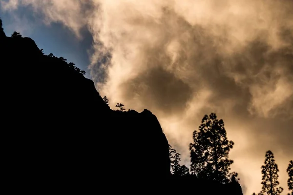 Der Bewölkte Himmel Über Den Silhouettierten Felsigen Hügeln — Stockfoto