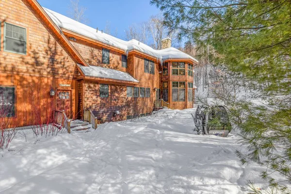 stock image A closeup of a contemporary rustic home covered in snow in the mountains