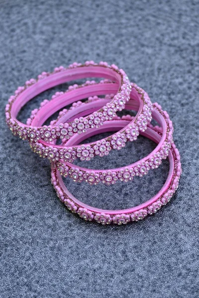 A vertical shot of female purple bracelets