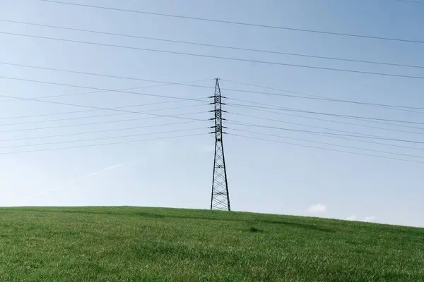 Strommasten Der Landschaft Hochspannungsmasten Mit Kabelleitungen Auf Dem Grünen Feld — Stockfoto