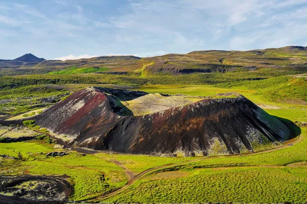 stock image A beautiful view of the Grabrok Volcano crater in Iceland during sunrise