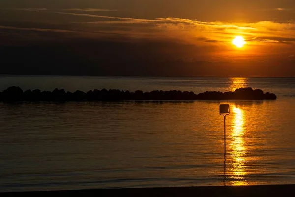 stock image A beautiful shot of a bright orange sunset sky over a sea