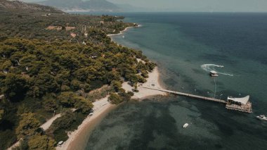 Ağaçlarla çevrili beyaz bir asanın havadan görünüşü