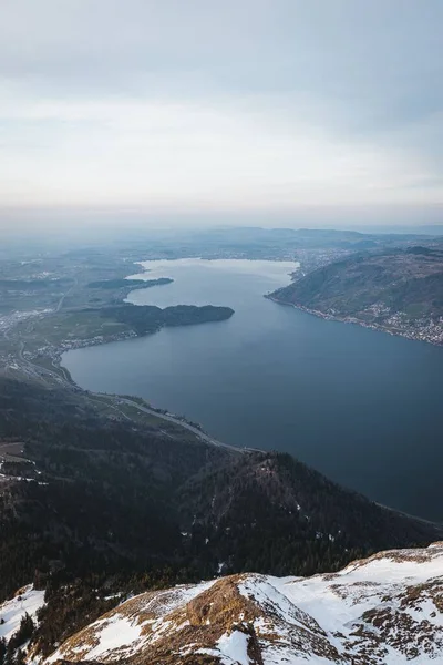 Bulutlu Bir Şafak Vakti Altında Dağlarla Çevrili Bir Gölün Dikey — Stok fotoğraf