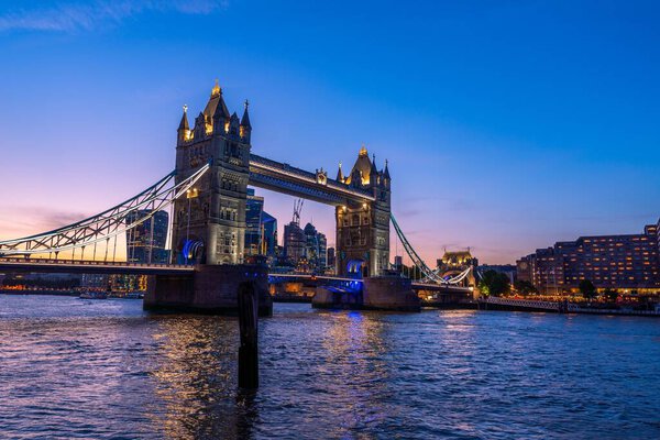 A scenic shot of the Tower Bridge and the city skyline in London, Europe during dusk
