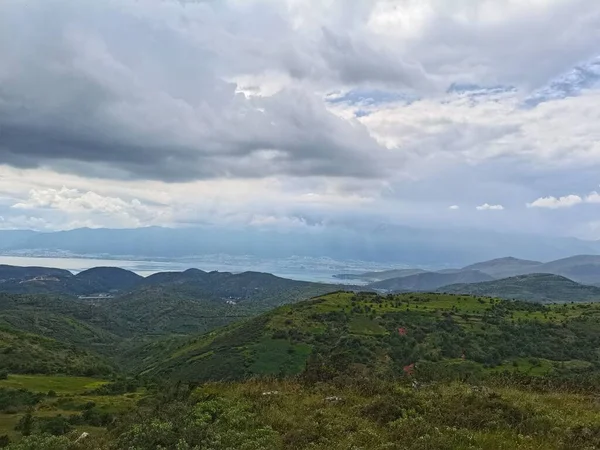 緑豊かな丘や谷が青空の下に広がる田園風景 — ストック写真