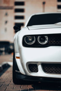 A vertical shot of a white Dodge Hellcat supercar headlight clipart