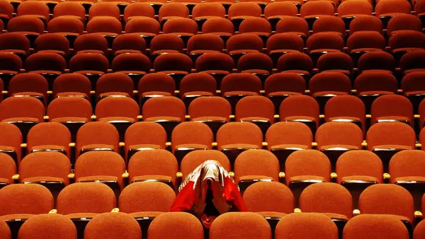 Una Persona Con Una Chaqueta Roja Dorada Cabeza Sentada Asiento — Foto de Stock