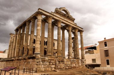 Arka planda gri kasvetli bulutlar olan Templo de Diana 'nın manzaralı bir çekimi.