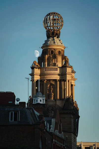 背景に月と青空に対するロンドンコロシアムの垂直ショット — ストック写真