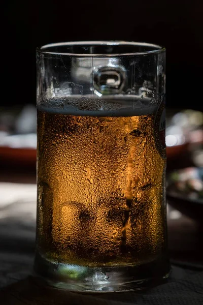 桌上放了一杯冰镇啤酒的特写镜头 — 图库照片