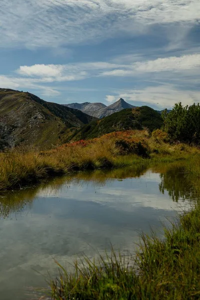 stock image A scenic view of a lake surrounded by rocky mountains in a rural area in Austria