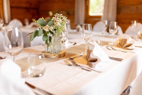 A closeup of table setting with flowers on a wedding day