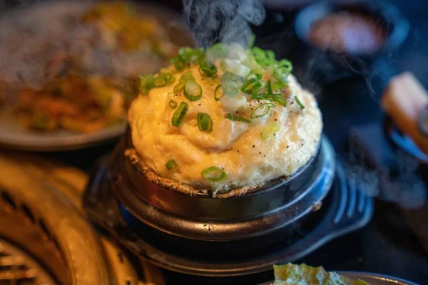 stock image A tasty cheese and egg souffle served in the restaurant with green chives on top