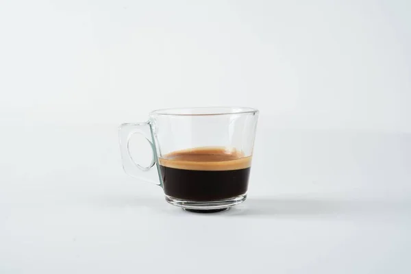 Ett Halvfullt Glas Espresso Vit Yta Isolerad Vit Bakgrund — Stockfoto