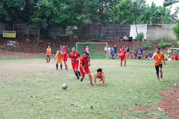 Bir grup genç Endonezya 'nın bağımsızlık gününü kutlamak için sahada futbol oynuyor.