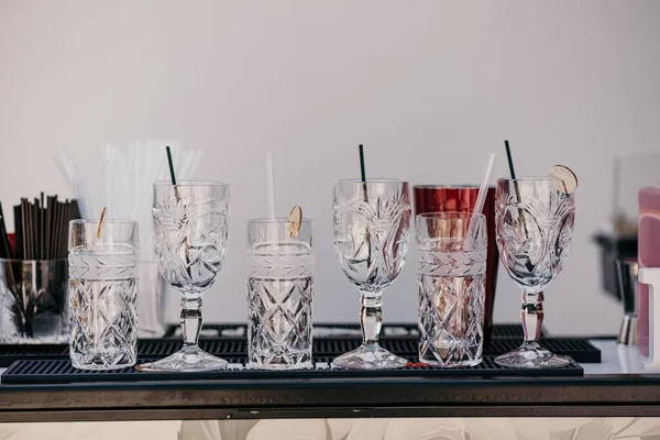 Beautiful Beverage Glasses White Wall — Stock Photo, Image