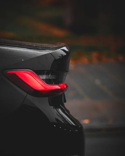 Vertical Shot Rear Lights Black Sports Car Blurred Background — Stock Photo, Image