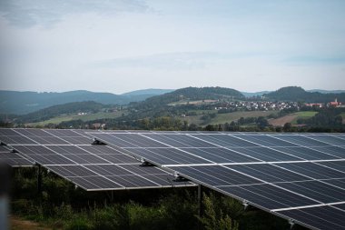 Güneş sistemi yeşil alandaki büyük fotovoltaik enerji santralinin panelleri.