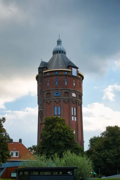 stock image The vertical low-angle view of De watertooren museum against the cloudy sky