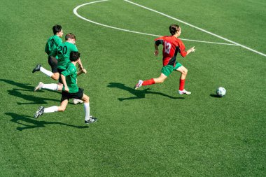 The high-angle view of a single soccer player chased by three adversaries across the field clipart