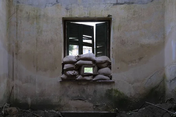 An abandoned house with sandbags at the window in Green Line in Nicosia