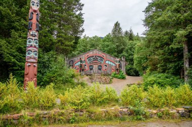 Saxman, Alaska - July 29, 2022: Tlinget totem poles, long house and traditional art.