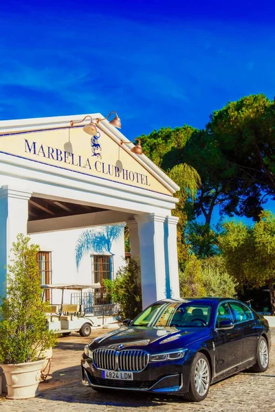 stock image A vertical shot of a luxury BMW 7 car parked near the entrance of Marbella club hotel. Spain