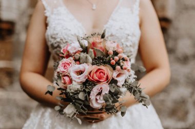 Elinde düğün buketi tutan genç bir gelin.