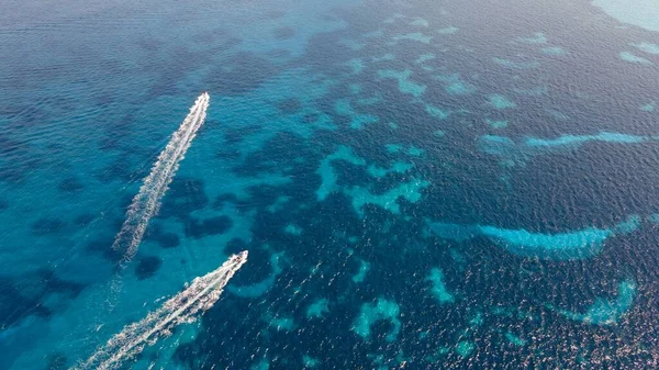 美しいターコイズブルーの海に水の道を描く2隻のモーターボートの空中 — ストック写真