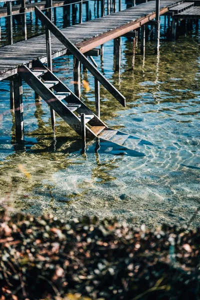 stock image A vertical view of a staircase to the sea with transperenet water