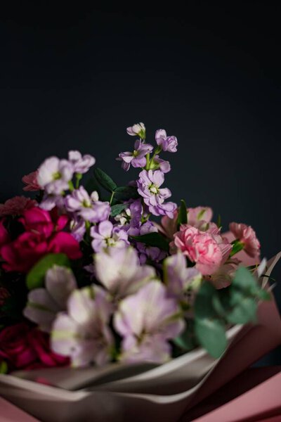 A Closeup of bouquet of flowers in pink and purple