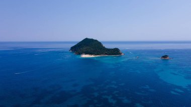 Etrafı mavi deniz manzarasıyla çevrili küçük bir ada.