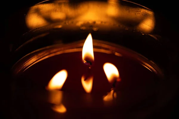 Ett Brinnande Ljus Med Lågor Och Deras Reflektion Vaxet Mörk — Stockfoto