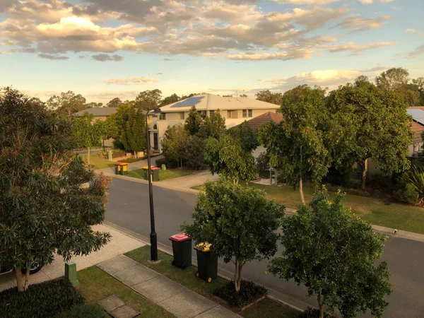 stock image An empty street in the middle of buildings surrounded by trees