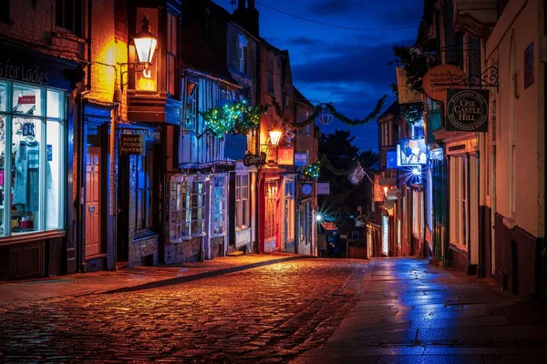 stock image The famous Steep Hill cobblestone street with the reflections of illuminated signs in the evening
