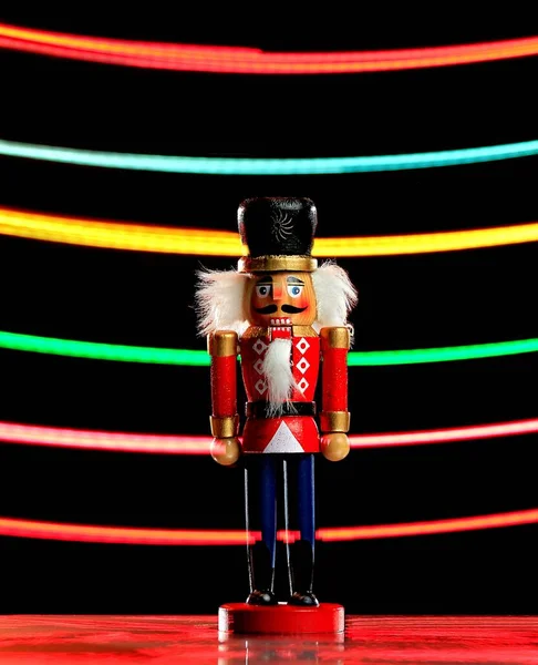 Vertical Shot Nutcracker Figure Colored Light Streaks Background — Stock Photo, Image