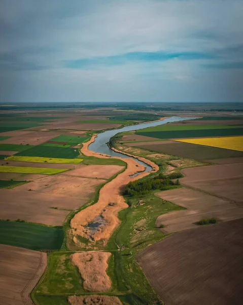 stock image A beautiful natural view of a colorful fields with a flowing river in the middle