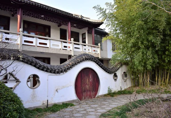 stock image A beautiful shot of a Chinese style moon gate on a curved wall