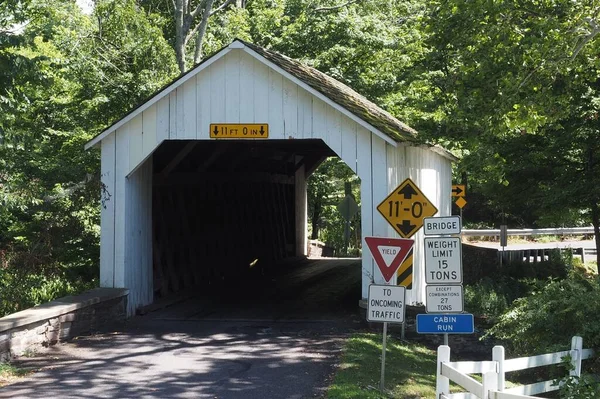 stock image A Covered Bridge in the woods made of wood and painted white