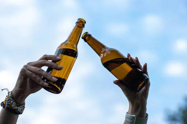 Closeup Shot Two Female Hands Lifting Two Bottles Beer Air — Stock Photo, Image