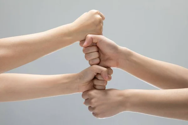 Closeup Shot Helping Hands Touching Front Gray Background — Stock Photo, Image