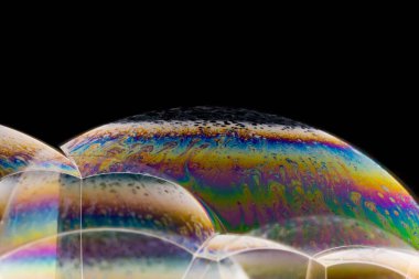 Siyah arkaplanda renkli sabun köpüklerinin makro çekimi